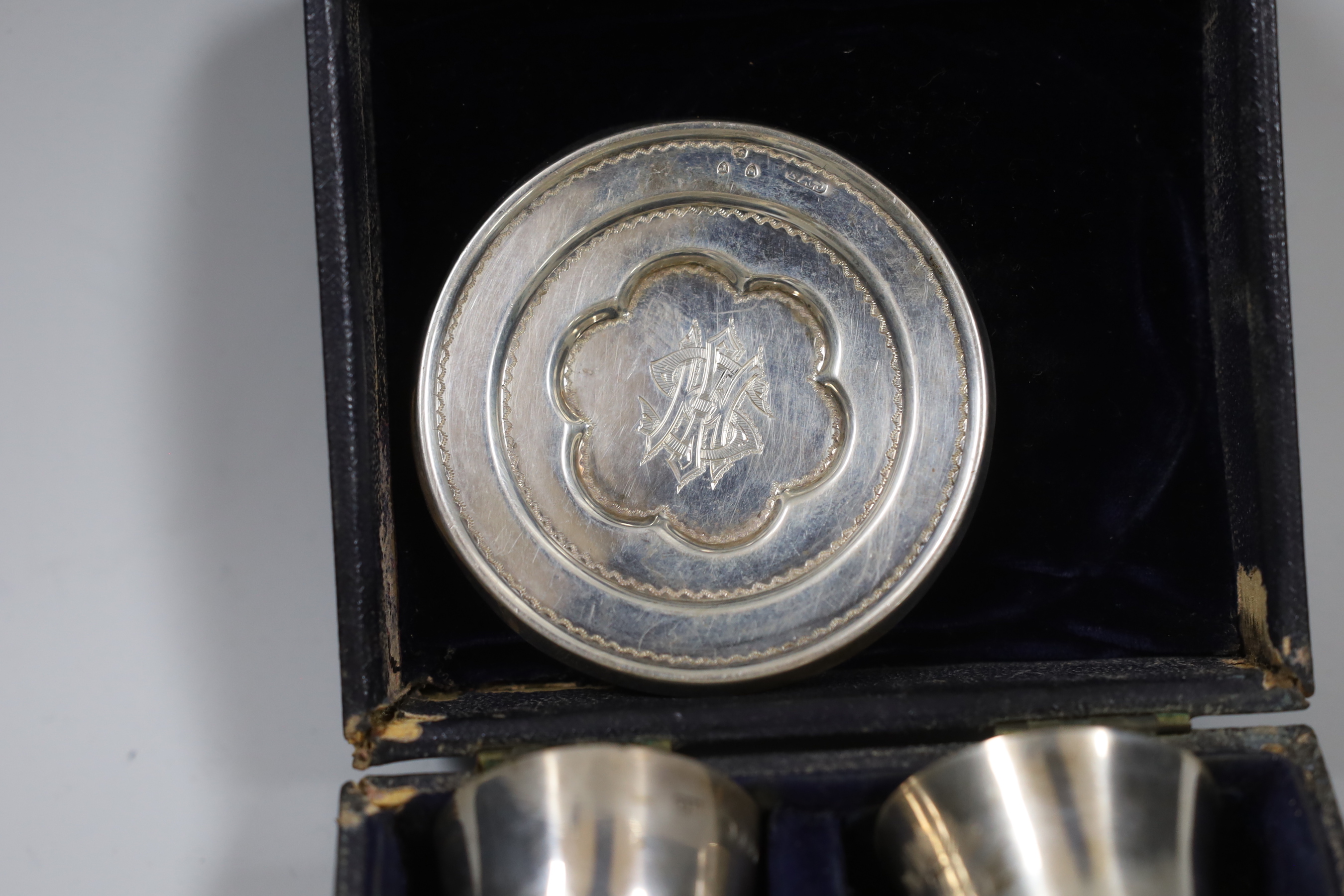 A cased matched Victorian silver travelling communion set, London, 1846, London, 1890 and Birmingham, 1850, tallest piece 78mm.